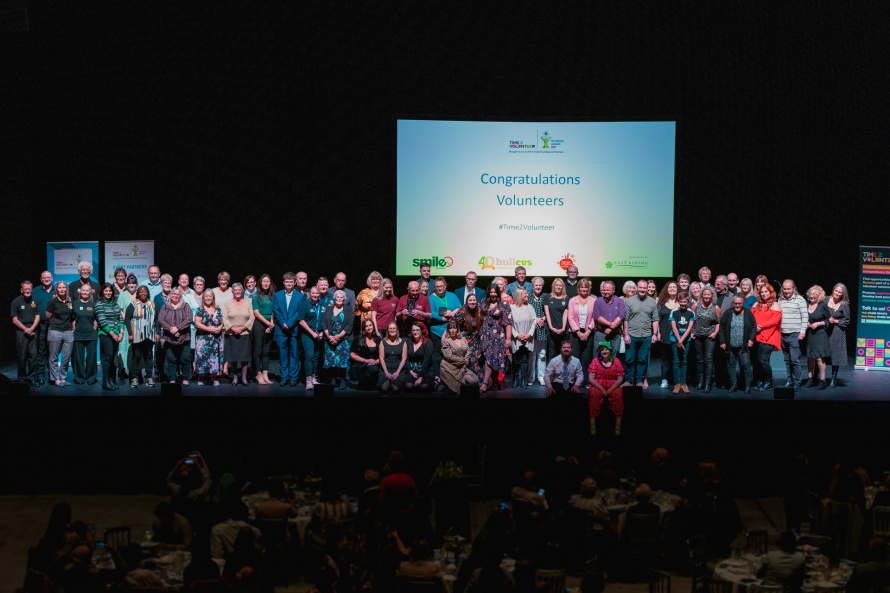 A large group of volunteer nominees on stage at the Time 2 Volunteer Awards 2022